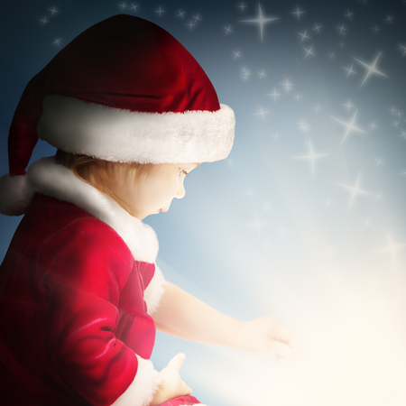 Christmas Child Open Gift on Background with Sparkle and Glitterの写真素材