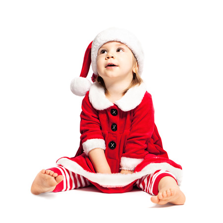 Cute Toddler in Christmas Santa Hat on Whiteの写真素材