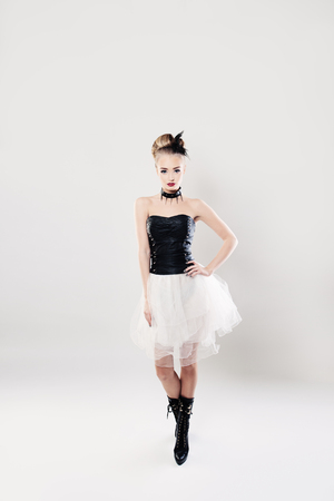 Fashionable Woman Standing on White Backgroundの写真素材