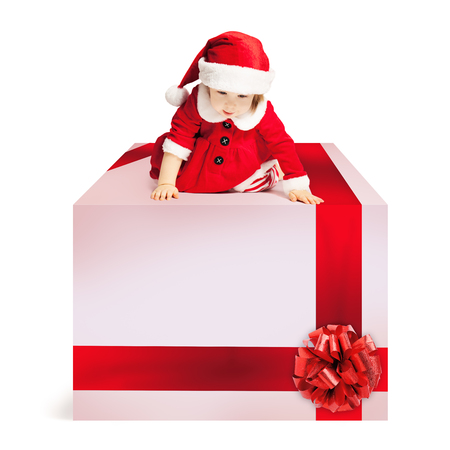 Christmas Gift Box and Baby in Santa Hat on White Backgroundの写真素材
