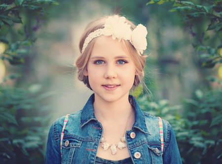 Young Girl on Green Foliage Background Outdoorsの写真素材