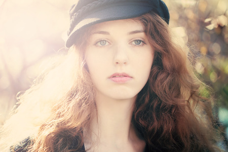 Beautiful Woman with Red Curly Hair Outdoors