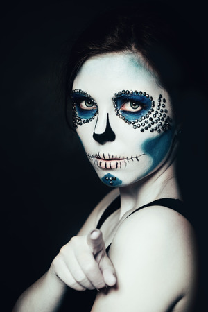 Woman with Halloween Makeup.  Sugar skull Beautiful Model. Santa Muerte concept.の写真素材