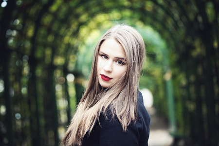 Pretty Woman Model on Greenery Background Outdoors