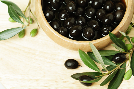 Olives with green leaf on background with copyspaceの写真素材