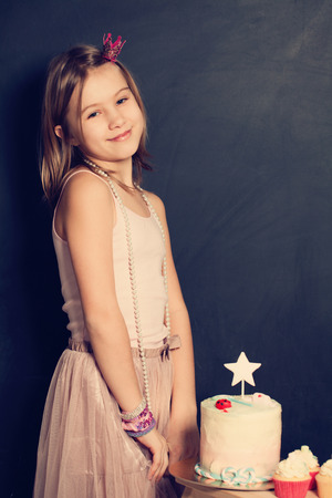 Happy girl and cupcake on birthday partyの写真素材