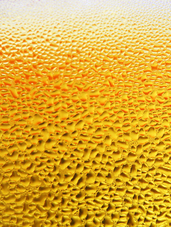 Beer bubbles macro yellow backgroundの写真素材