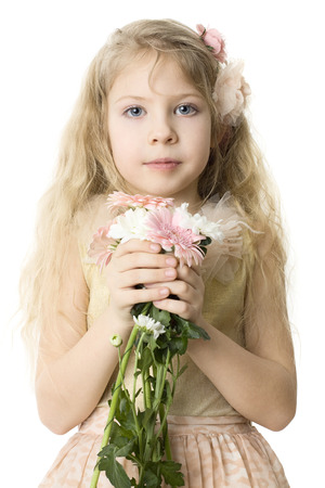 Beautiful child with spring flowers isolated on whiteの写真素材