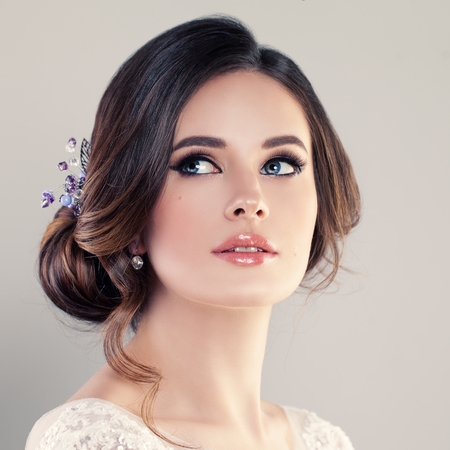 Beautiful Bride with  Makeup and Bridal Hairstyle. Pretty Woman Fiancee Looking Up, Face Closeupの写真素材