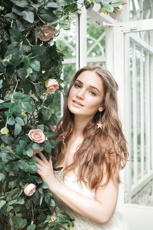 Beautiful Young Woman in Blossom Garden Outdoorsの写真素材