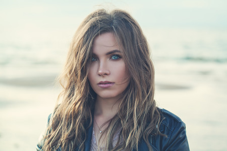 Magnificent Woman with Curly Hairstyle and Makeup on Nature Backgroundの写真素材