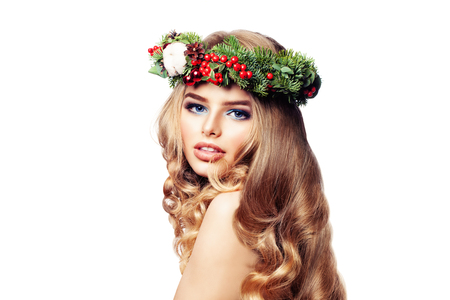 New Year Portrait of Beautiful Fashion Woman with Long Wavy Hair wearing Christmas Wreath. Beauty and Haircare Conceptの写真素材