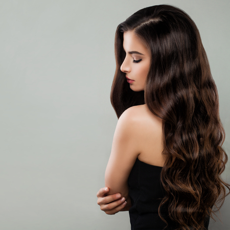 Gorgeous Woman in Black Dress Posing. Perfect Face, Hairstyle and Makeupの写真素材