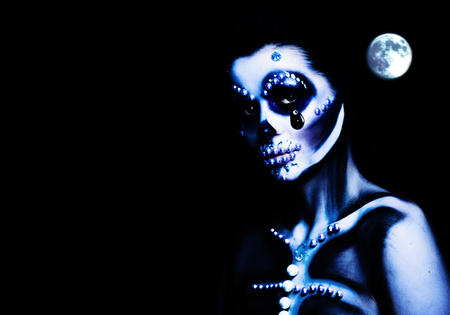 Woman with Halloween Makeup on Dark Background. Halloween Skeleton Make Upの写真素材