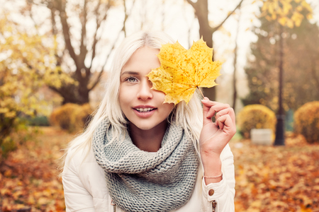 Happy woman in Autumn Park Outdoorsの写真素材