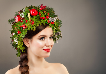 Christmas Woman with Xmas Tree Wreath, Makeup and Braid Hairstyle on Banner Background. Christmas Conceptの写真素材