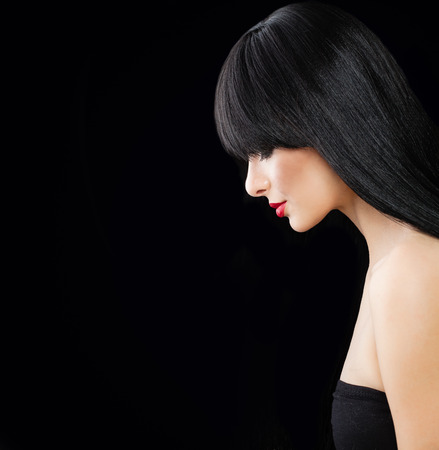 Perfect Fashion Model with Long Silky Hair. Beautiful Hair style Woman on Black Backgroundの写真素材