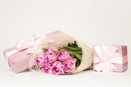 Beautiful pink flowers and gift box on white backgroundの写真素材