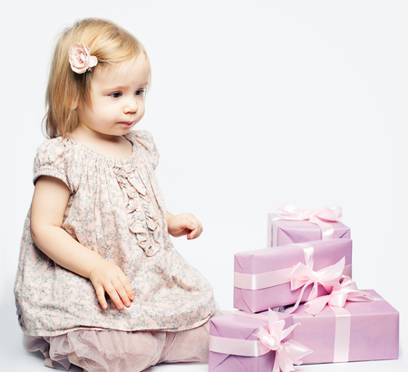 Cute baby girl with gift box, birthday backgroundの写真素材