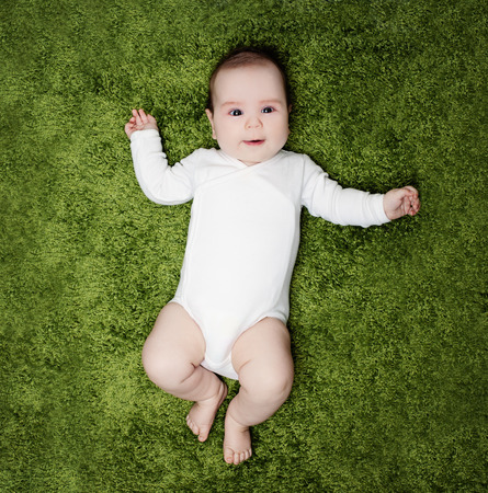 Happy baby lying on white background, top view. Child, 2 months oldの写真素材