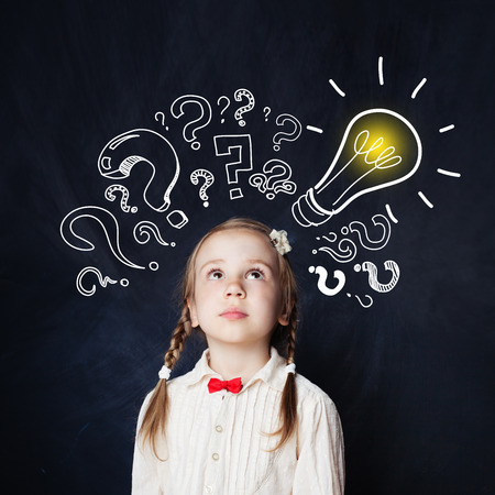 Little girl with lightbulb portrait. Ideas, doubt and Hope conceptの写真素材