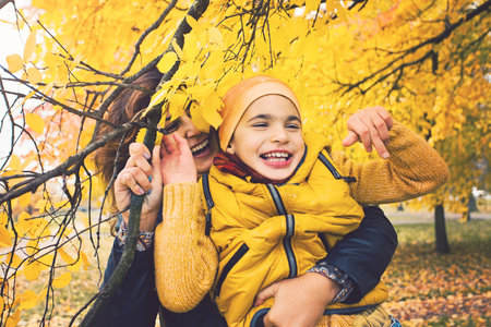 Smiling little boy, kid with disabilities and his mother. Child has cerebral palsyの写真素材