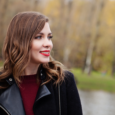 Cheerful woman outdoors, closeup portraitの写真素材