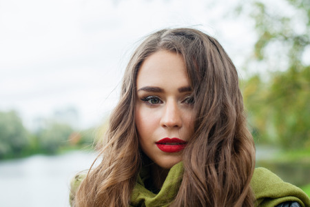 Beautiful woman outdoor, face closeup. Perfect female model with healthy hair and makeupの写真素材