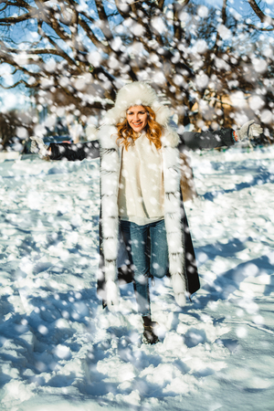 Winter woman having fun with snow outdoorの写真素材