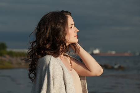 Perfect woman looking at skyline outdoors. Beautiful girl romantic portraitの写真素材
