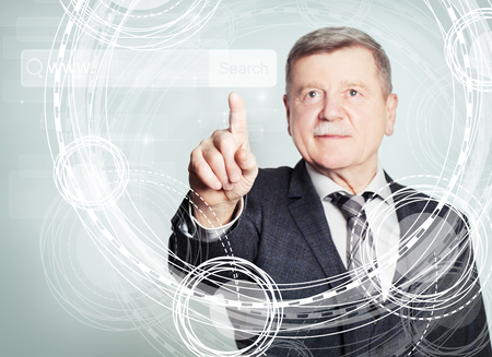 Happy mature businessman pointing to empty address bar in virtual web browserの写真素材
