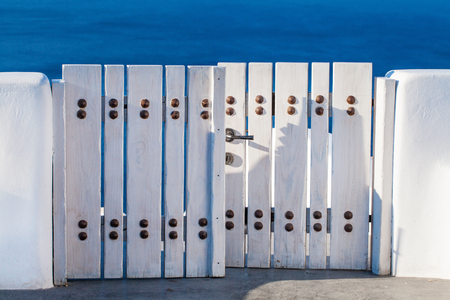 White and blue details. White wooden gate and sea, Santorini, Greeceの写真素材