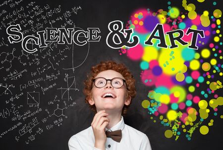 Clever child boy looking at maths formula and art pattern background. Brainstorming, creativity and...