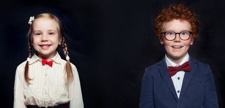 Cheerful little children on black board backgroundの写真素材