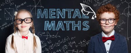 Mental maths concept with little kids student on blackboard background with science and maths formulaの写真素材
