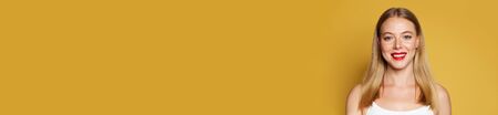 Positive young model woman with blonde hair on bright yellow banner background