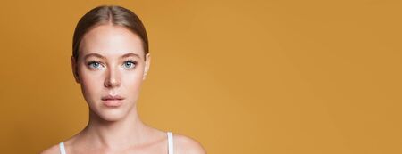 Nice woman on yellow backgroundの写真素材