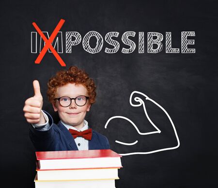 Confident smart child student showing thumb up. Possible and a lot of possibilities conceptの写真素材