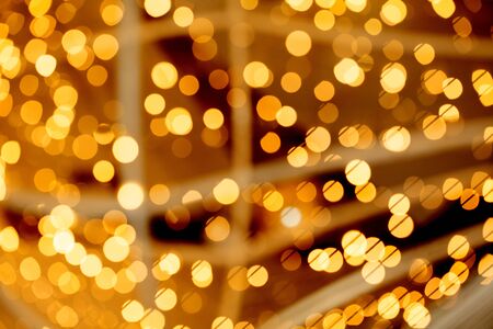 Christmas bokeh light background. Golden bokeh from Xmas decoration garland at night party