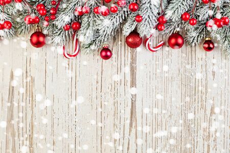 Winter card background. Red Christmas decoration on white wooden background with snowの写真素材