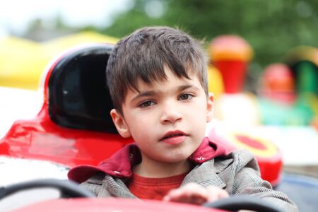Happy Little boy in park attraction. Concept joy and Holidayの写真素材