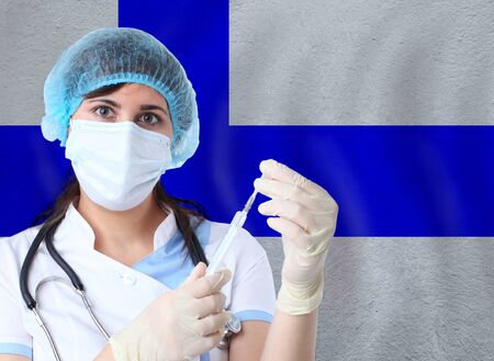 Scientist woman with test tube Coronavirus or COVID-19 against Finland flag. Research of viruses in laboratory for prevention of a pandemic in Finlandの写真素材