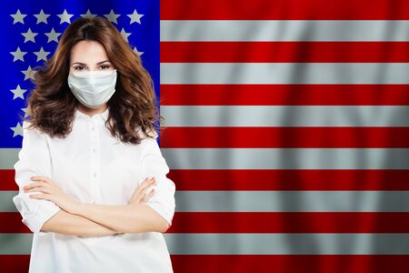 Doctor or nurse in medical face mask with USA flag. Flu epidemic and virus protection in US concept