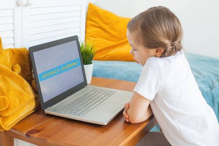Kid learning at home. Little child girl using laptop. Advance learning and Distance education...