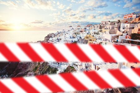 Santorini with warning tape. Oia town, Greece landmark, delayed vacation conceptの写真素材