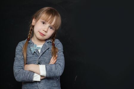 Cute child girl on black backgroundの写真素材