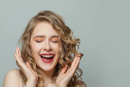 Portrait of happy excited woman on whiteの写真素材