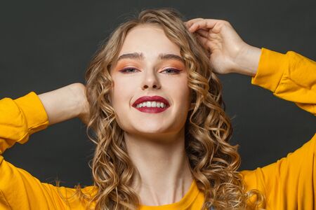 Young beautiful woman smiling, perfect female face close up