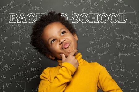 Child against chalkboard background. Back to school conceptの写真素材