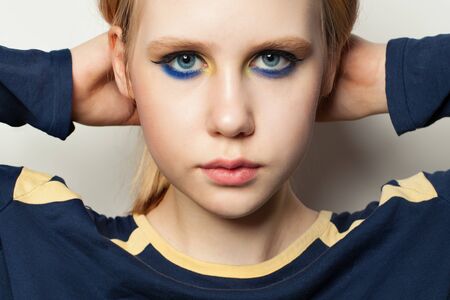 Teenager girl with makeup, face close up